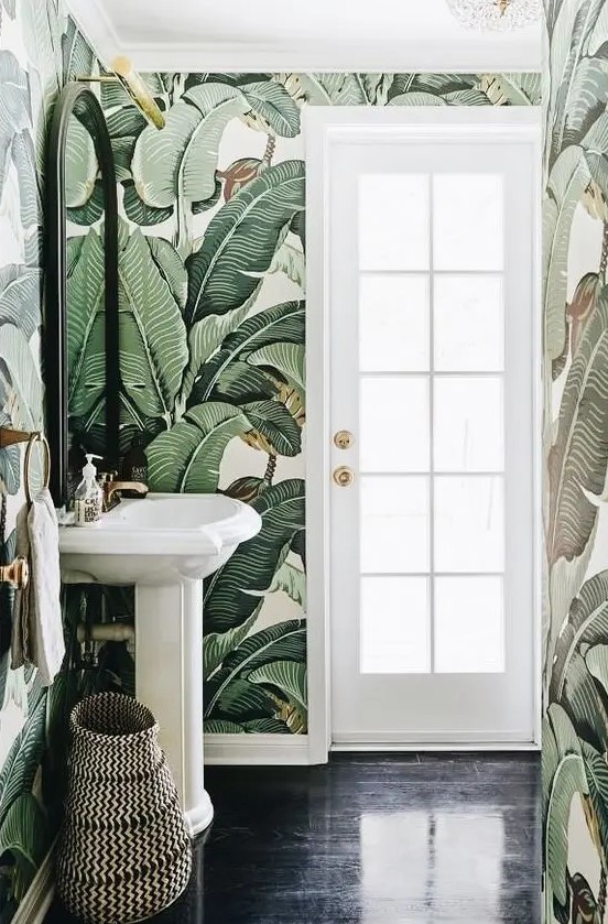 eye catchy banana leaf wallpaper makes the powder room eye catchy and bold