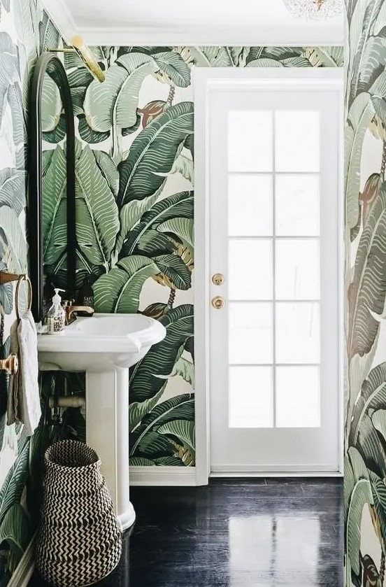 eye-catchy banana leaf wallpaper makes the powder room eye-catchy and bold