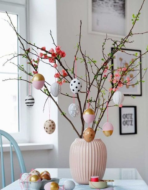 faux blooming branches with colorful and decorated Easter eggs are amazing as an Easter tree, this is a great centerpiece