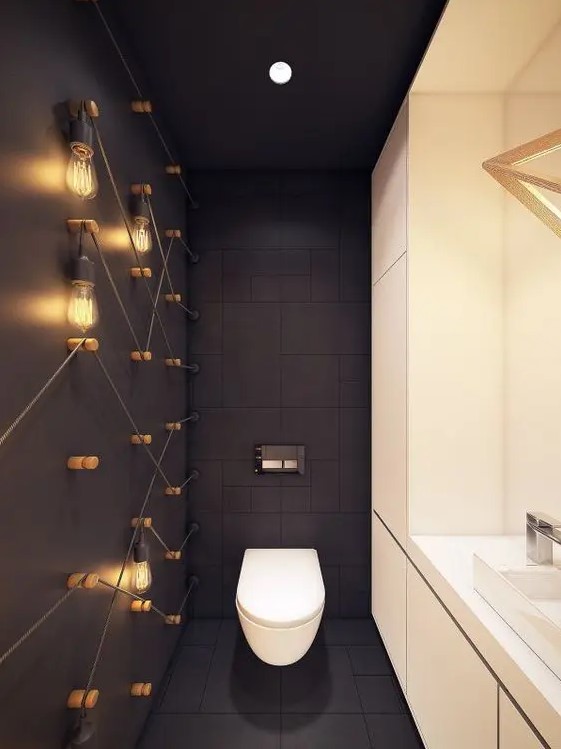 matte black tiles and a black matte wall with bulbs all over create a chic and bold modern look