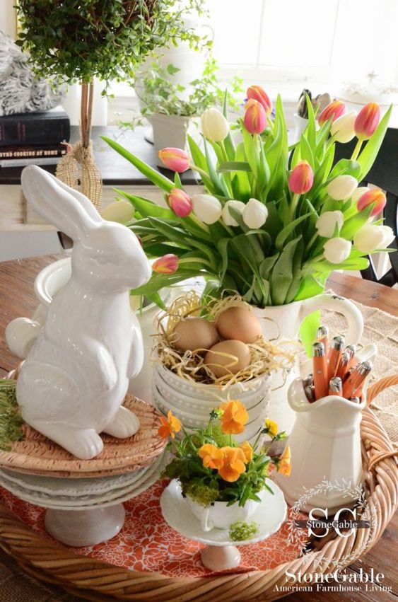 rustic Easter decor with a bunny, bright tulips and potted blooms and some eggs in a mug is great