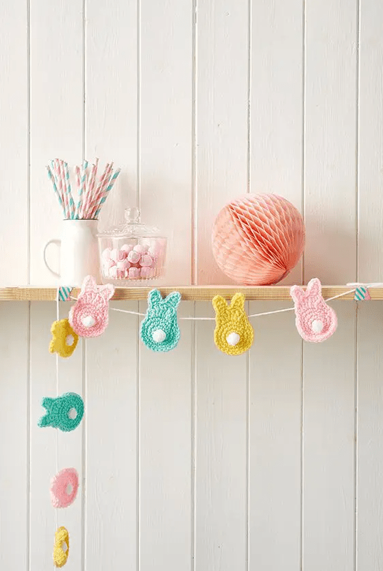 such a pastel crochet bunny garland can decorate a mantel, a front door, a console table or any other space