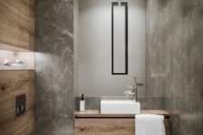 using grey marble tiles and wood-looking tiles is a chic and creative solution for a powder room