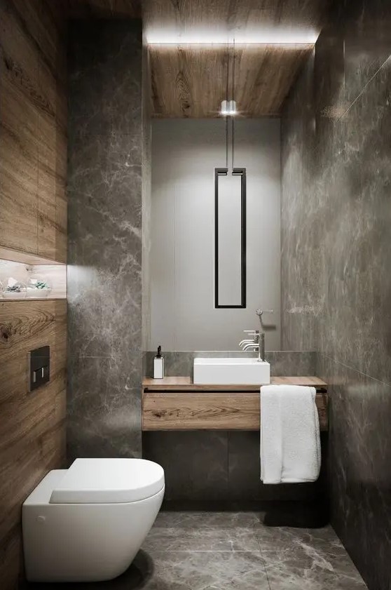 using grey marble tiles and wood looking tiles is a chic and creative solution for a powder room