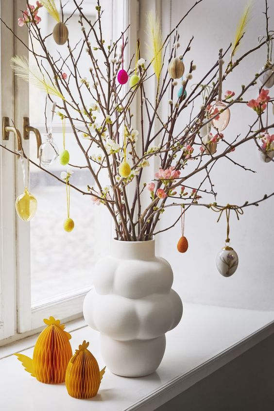 willow and blooming branches decorated with pastel and colorful plastic eggs are a lovely idea for Easter