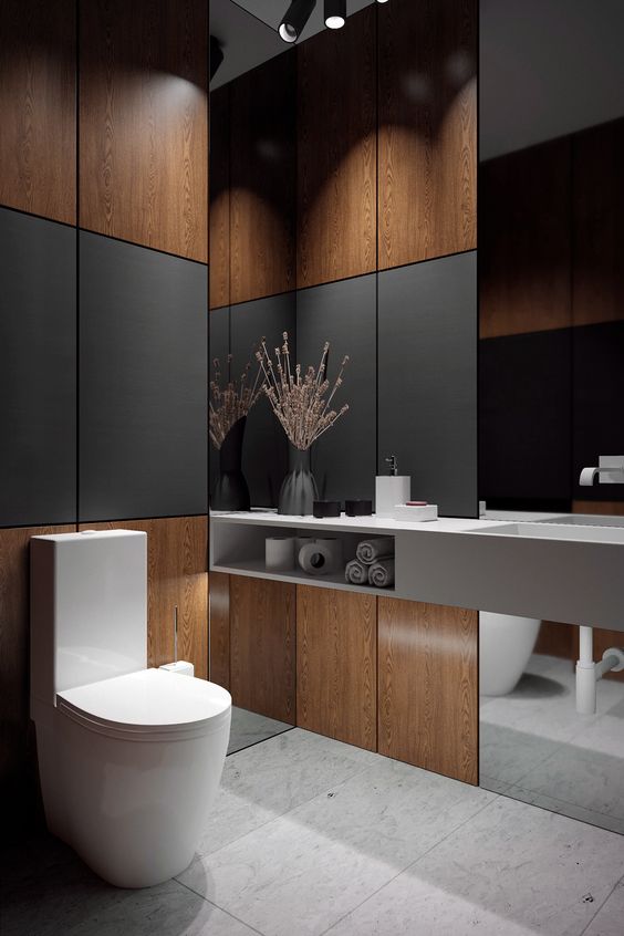 a contemporary guest toilet with plywood and black panels, a mirror, a concrete vanity and some built-in lights