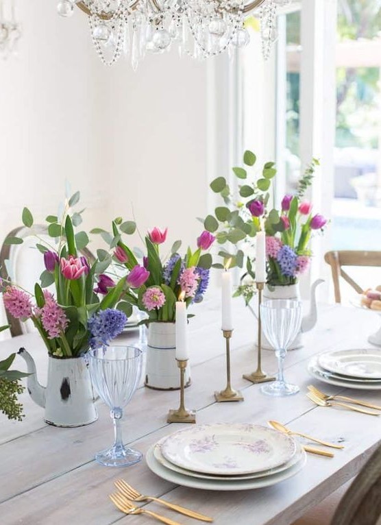 a bright Mother's Day table setting with colorful floral centerpieces, gilded touches and an uncovered table