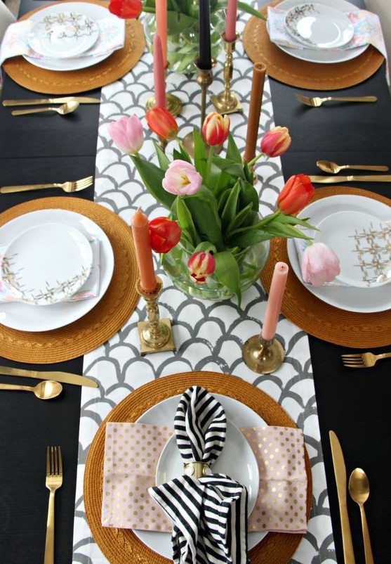 a fish scale runner, pink candles, a bright tulips centerpiece, wicker chargers and printed napkins