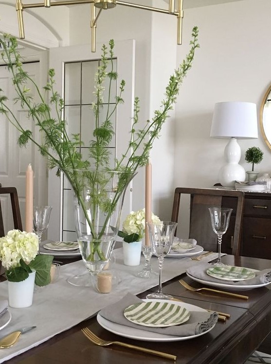 a fresh spring tablescape in green and cremay, with branches, hydrangeas and striped plates