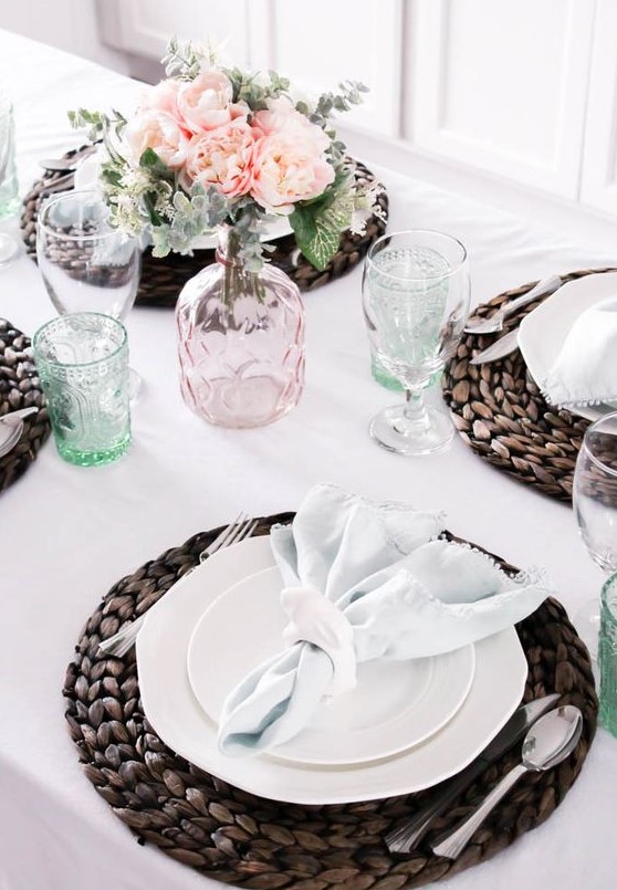 a neutral spring tablescape with pastel glasses and blooms is added drama with dark wicker chargers