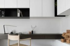 a bold minimalist home office in black and white, with sleek storage units and an open shelf, a built-in dark-stained desk and a woven chair