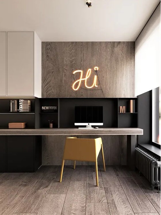 a contemporary home office with light stainted wood, black and white touches, a floating desk and sleek storage units and a yellow chair