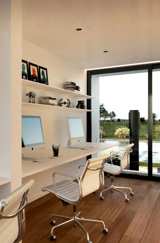 a contemporary shared home office nook by a glazed wall, with a floating desk, white chairs, open shelves and a lovely view