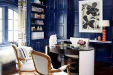 a luxurious blue home office with bright walls, a round desk, white furniture, a quirky chandelier, an acrylic bench with faux fur