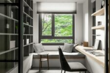 a minimalist home office with a windowsill daybed, a large storage unit, floating shelves and a desk, a grey chair