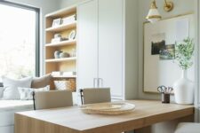 a neutral organic home office in dove grey, with a large wooden desk, a cupboard and a storage unit and a window daybed
