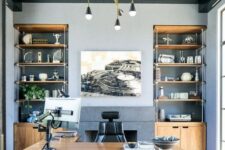 a refined beach home office with grey walls, a black wooden ceiling, built-in storage units and a large stained desk plus a sea-inspired rug