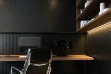 a stylish moody minimalist home office with a wood slab wall and a sleek storage unit, an open shelving unit and a floating desk plus a black chair