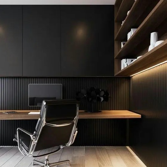 a stylish moody minimalist home office with a wood slab wall and a sleek storage unit, an open shelving unit and a floating desk plus a black chair