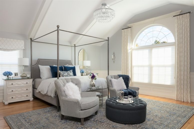 a welcoming bedroom with dove grey furniture and a grey rug plus some navy accents like pillows