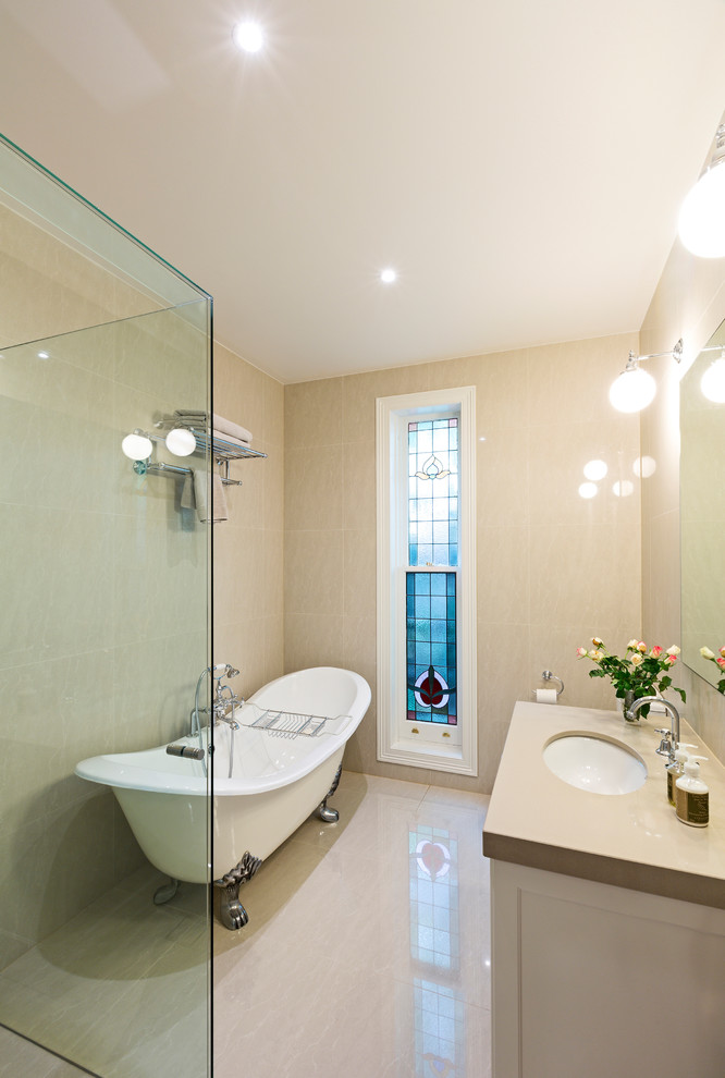 a beige and creamy bathroom with bubble lamps and a modern glass clad shower space (Period Extensions &amp; Designs)