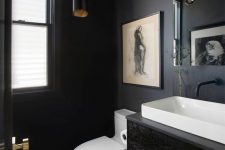 a black vintage powder room with a black floating vanity, white appliances, a cluster of pendant bulbs and a vintage artwork