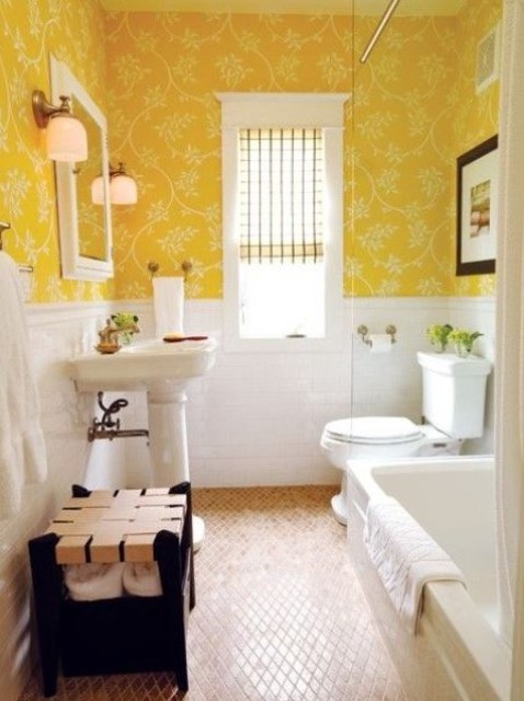 a bright vintage bathroom with sunny yellow wallpaper, white tiles and white appliances with a vintage feel