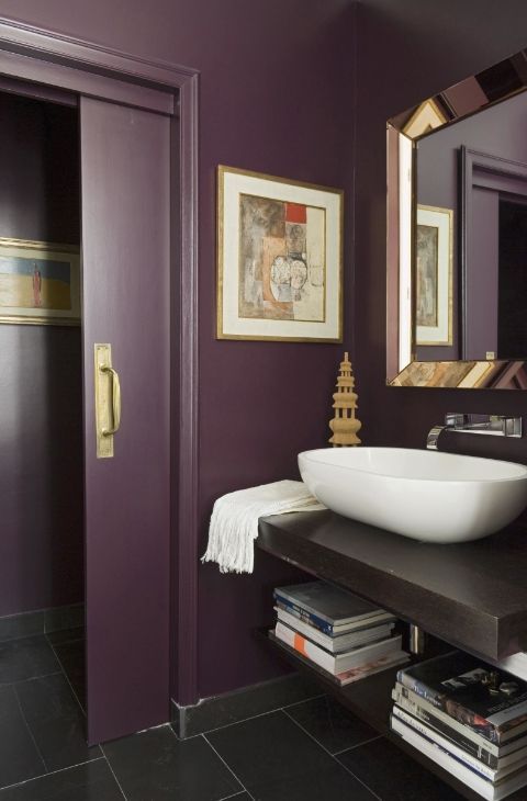 a chic purple bathroom, a floating vanity, metallic touches, a vessel sink and sliding doors