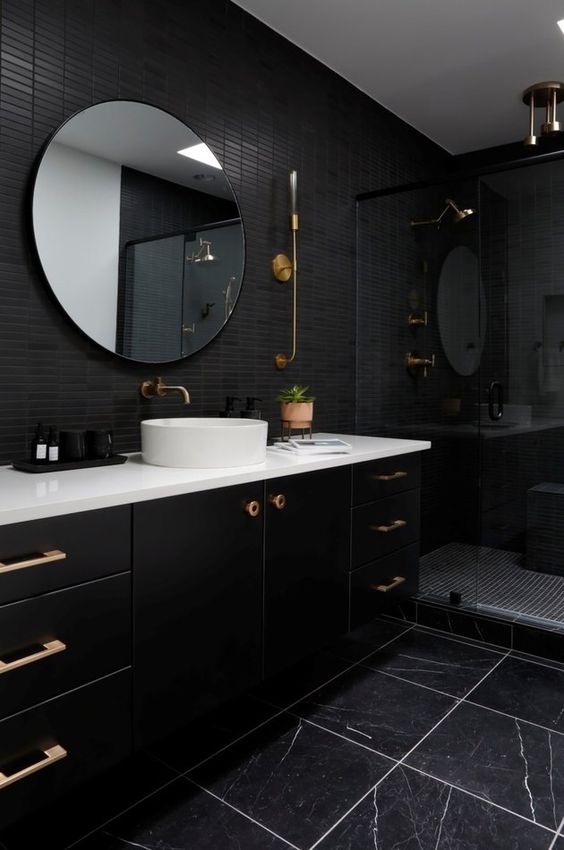 حمامات باللون الاسود A-modern-black-bathroom-with-skinny-and-black-marble-tiles-a-large-black-vanity-a-shower-space-and-a-round-mirror