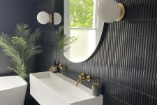 a lovely tropical bathroom design with black walls