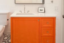 a monochromatic bathroom spiced up with a bright orange vanity – just repaint your existing one and voila
