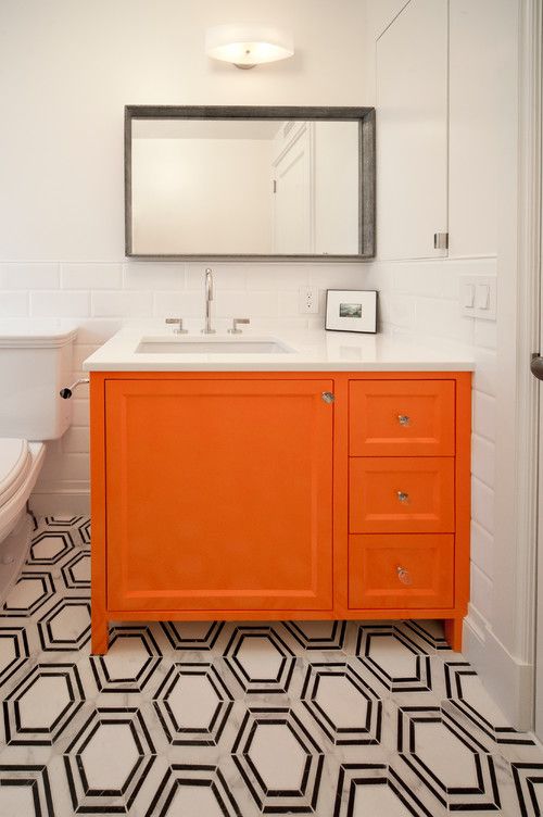 a monochromatic bathroom spiced up with a bright orange vanity - just repaint your existing one and voila
