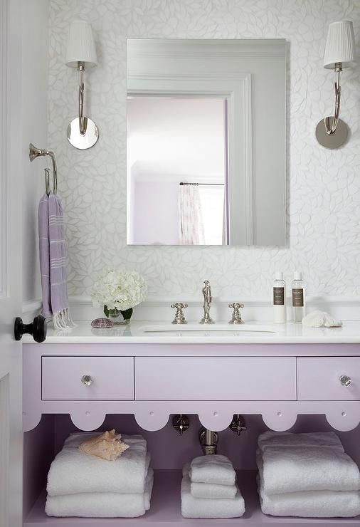 a romantic bathroom with a lavender vanity, a white stone countertop, metallic touches is a beautiful space