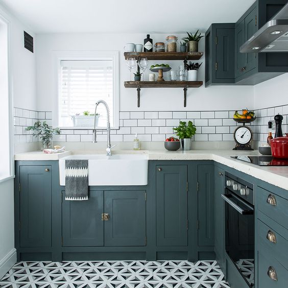 a small farmhouse kitchen done in graphite grey, with white countertops, open shelves and a mosaic tile floor plus a subway tile backsplash