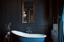 a gorgeous black bathroom design with a blue bathtub