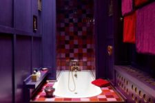 a whimsical Moroccan-inspired bathroom with purple and aubergine walls, bright mosaic tiles, a gallery wall and a heart-shaped rug