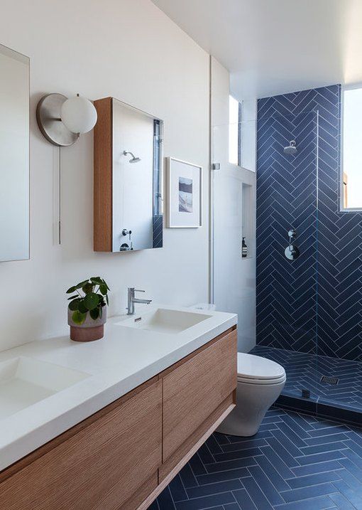 navy blue ceramic tiles in herringbone pattern on bathroom wall and floor for a contemporary rustic bathroom