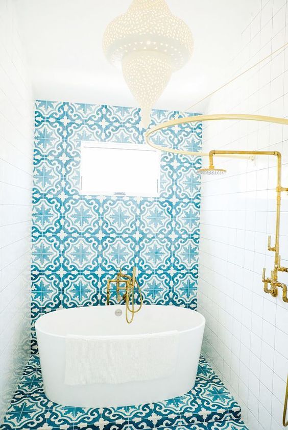 white tiles paired with blue mosaic ones and with gold touches for a bright and welcoming space