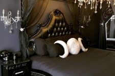 a stylish bedroom with black walls