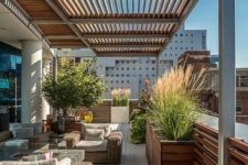 a modern rooftop terrace with wicker furniture, a firepit coffee table and some potted plants here and there