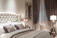 a vintage glam bedroom with a white leather bed and chair, mirror furniture, a vintage mirror and lilac touches