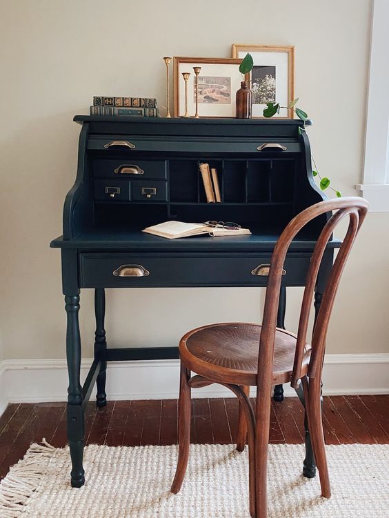 a vintage working spot with a navy bureau desk and a stained chair some art and greenery is a lovely idea for your home