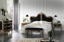 an elegant bedroom with a splash of Gothic style, an exquisite black bed, dresser and nightstands plus black lamps and vases