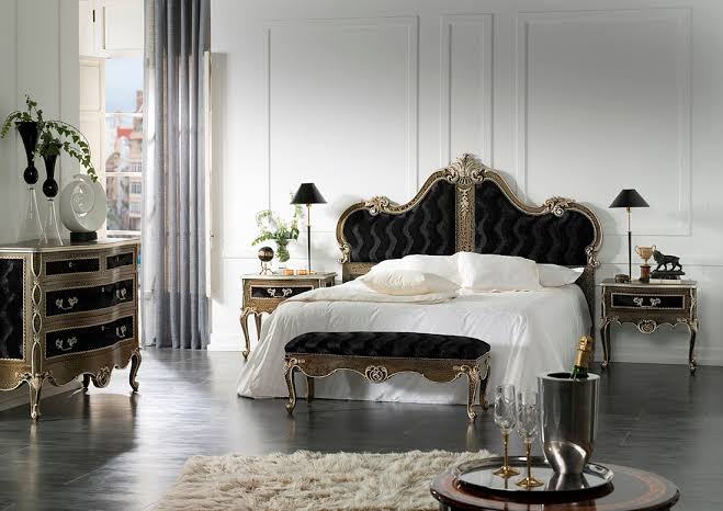 an elegant bedroom with a splash of Gothic style, an exquisite black bed, dresser and nightstands plus black lamps and vases