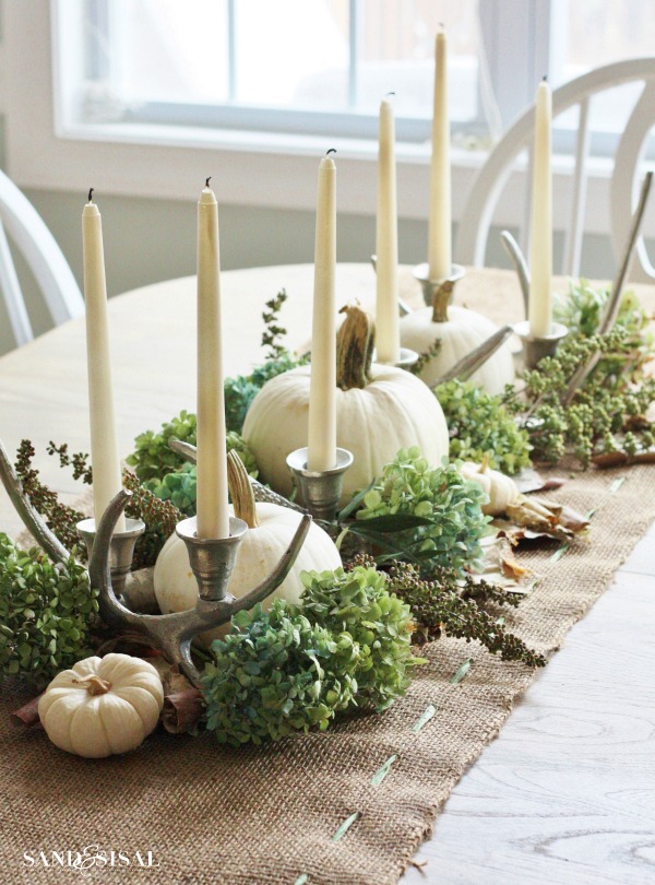 awesome pumpkin centerpieces for fall and halloween table Dried hydrangea, birch bark and candelabras are a great company to white pumpkins on a natural-looking burlap table runner.