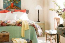 a bright fall bedroom with a neutral base and colorful details in greens, orange, rust and yellows