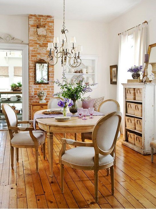 a lovely neutral French chic dining room with an oval table and vintage chairs, a neutral storage unit with baskets, a lovely wall-mounted unit