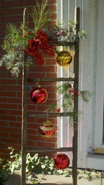 An old ladder could become could be used in different holiday arrangements for front porch.