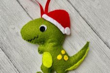 a colorful dinosaur ornament of felt with a cone hat is a fun and bold idea for winter, your kids will be very happy