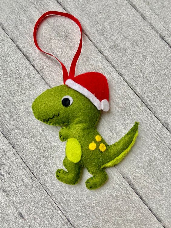 a colorful dinosaur ornament of felt with a cone hat is a fun and bold idea for winter, your kids will be very happy